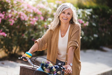 A woman smiling on a bike. Links to Gifts of Appreciated Securities A woman smiling on a bike. Links to Gifts of Appreciated Securities